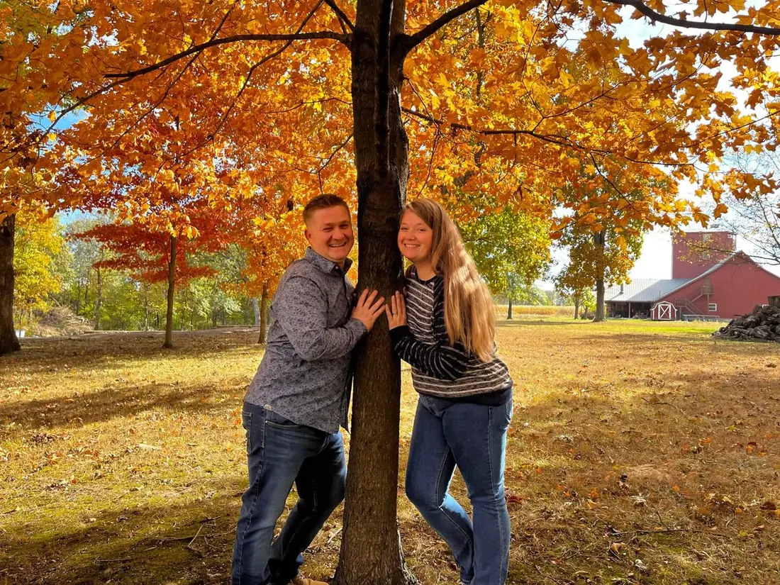 A couple from our church family under autumn maple trees